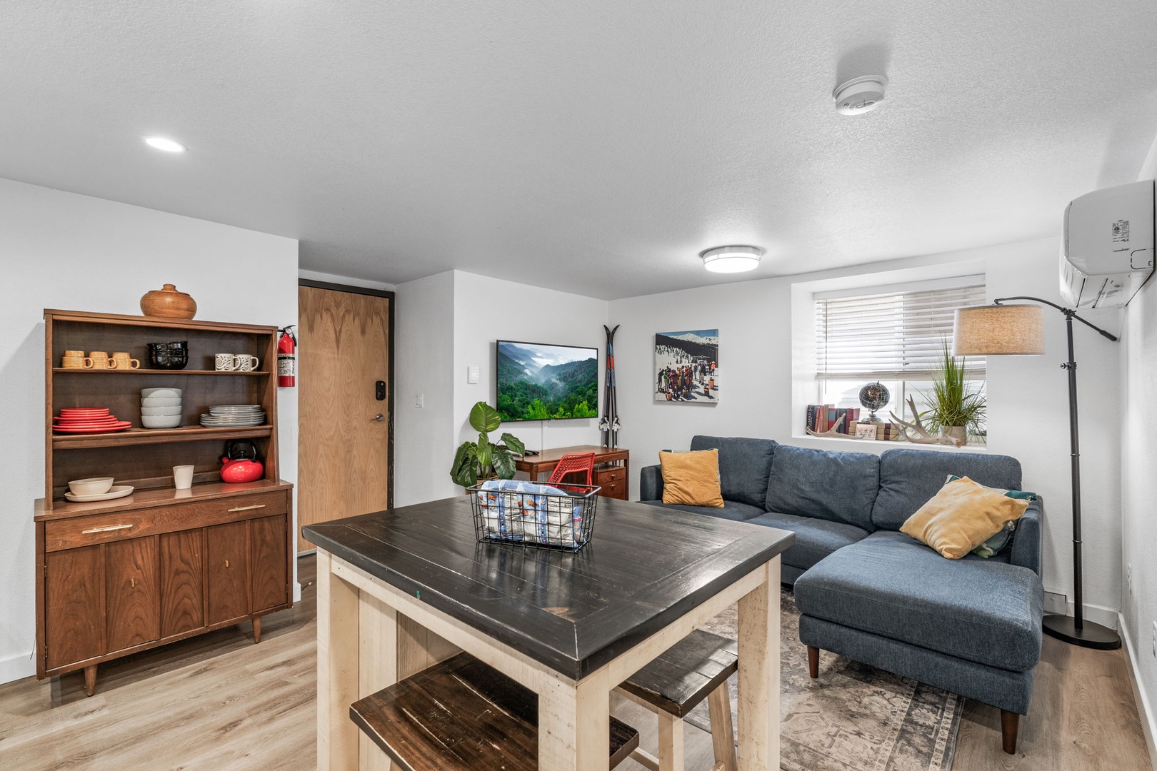 Your bright living space combines comfort and style with a cozy sectional sofa, curated artwork, and thoughtful touches throughout.