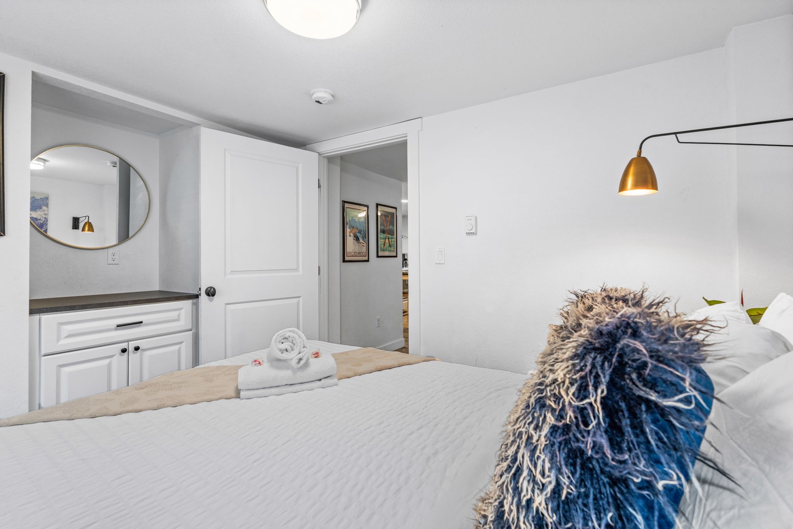 Sink into your cozy bed with crisp linens and fluffy towels awaiting your arrival in this thoughtfully designed bedroom.