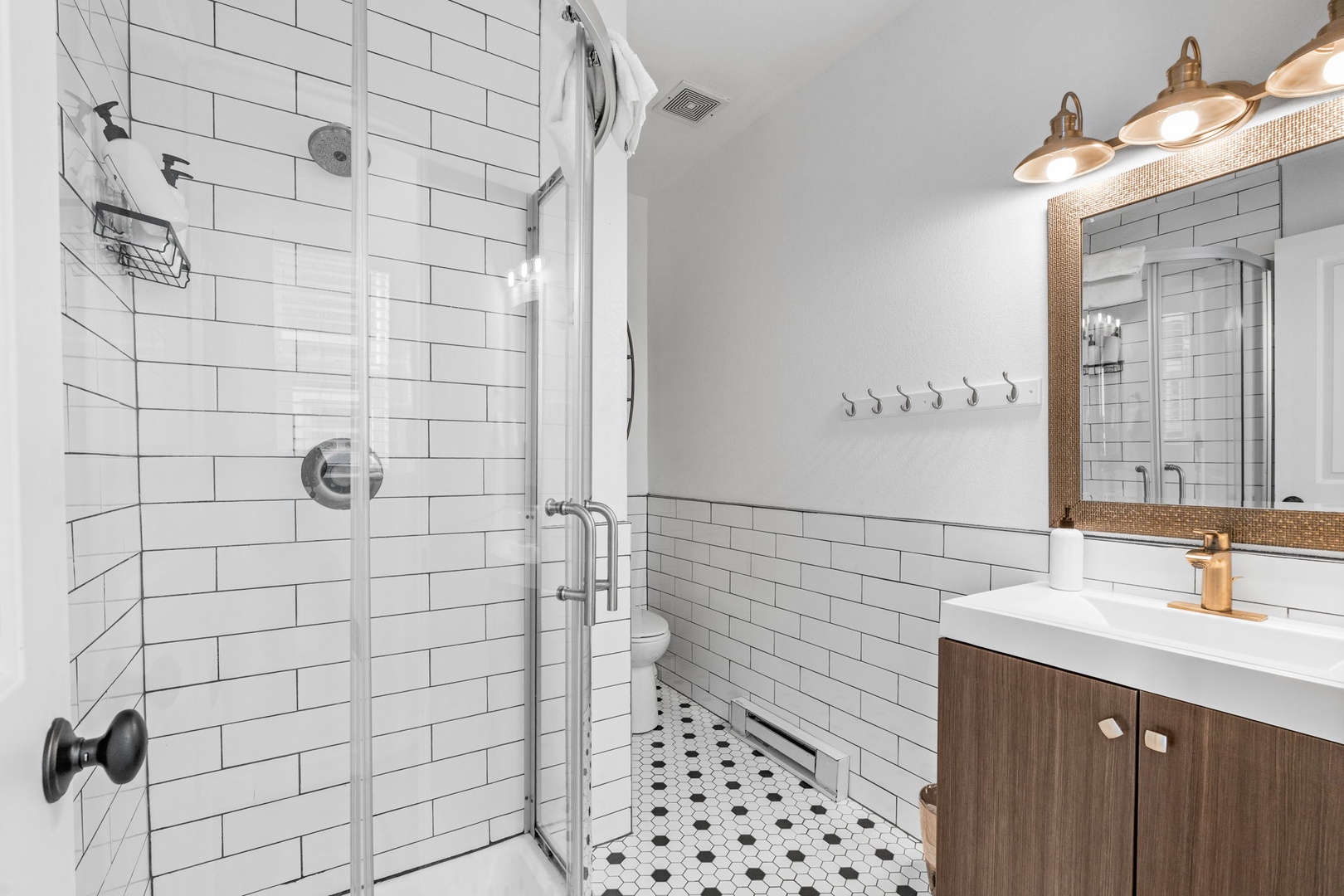 Step into your stylish bathroom featuring classic subway tiles, modern fixtures, and warm wood accents that create the perfect spa-like retreat.