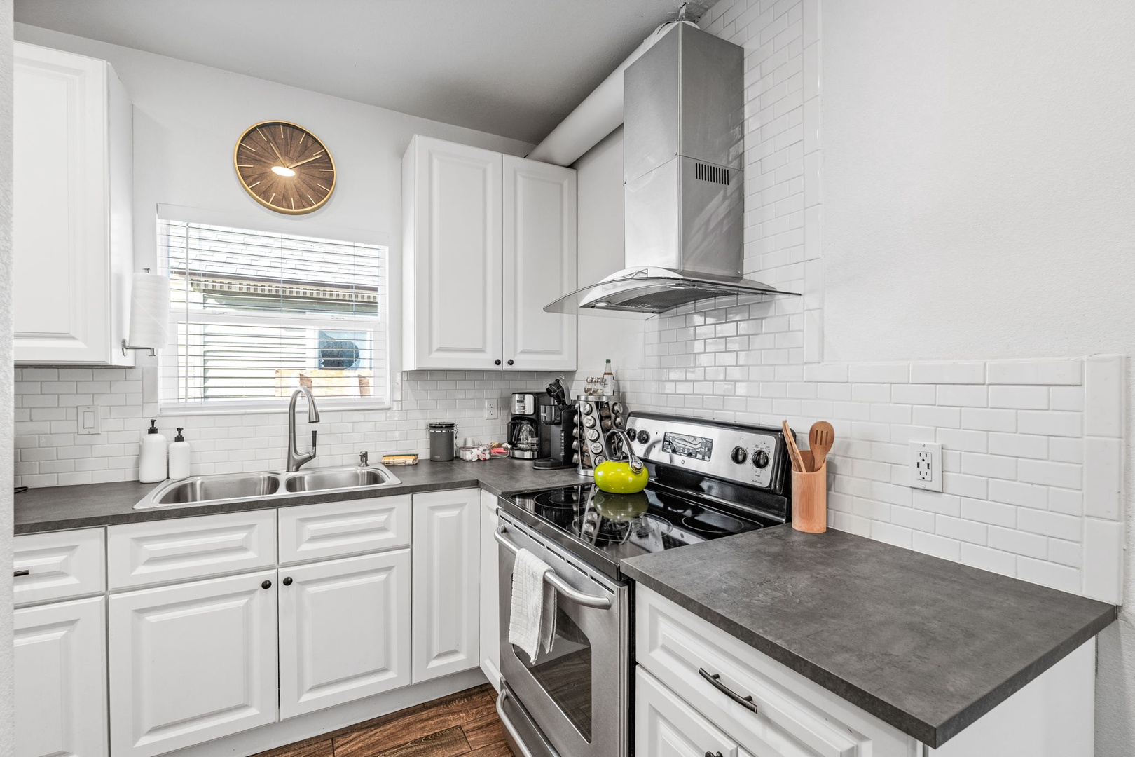 Your fully-equipped kitchen awaits with sleek white cabinets, modern appliances, and elegant countertops—perfect for preparing memorable meals during your stay.