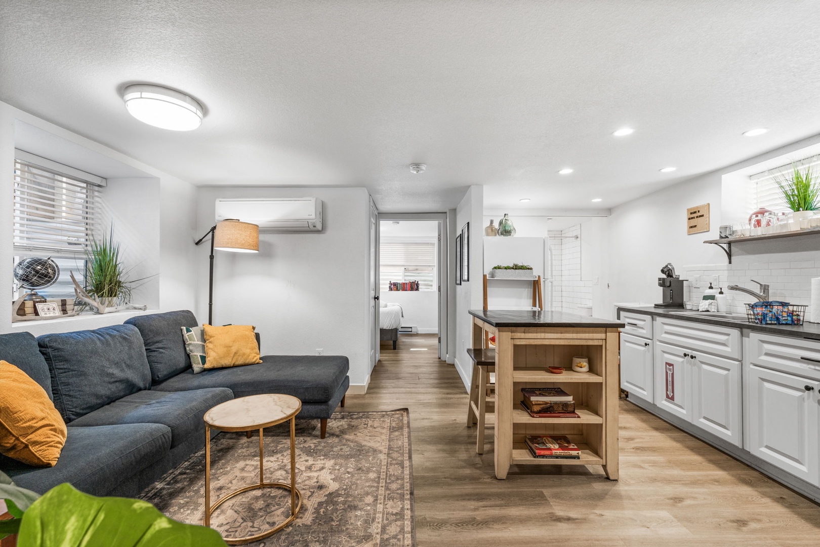 Relax in your bright, open-concept space where modern comfort meets home. The cozy sectional and full kitchen create the perfect blend for both relaxation and convenience.