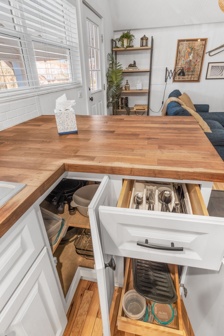 Your fully equipped kitchen features rich butcher-block counters and smart storage solutions with organized drawers for all your cooking essentials.