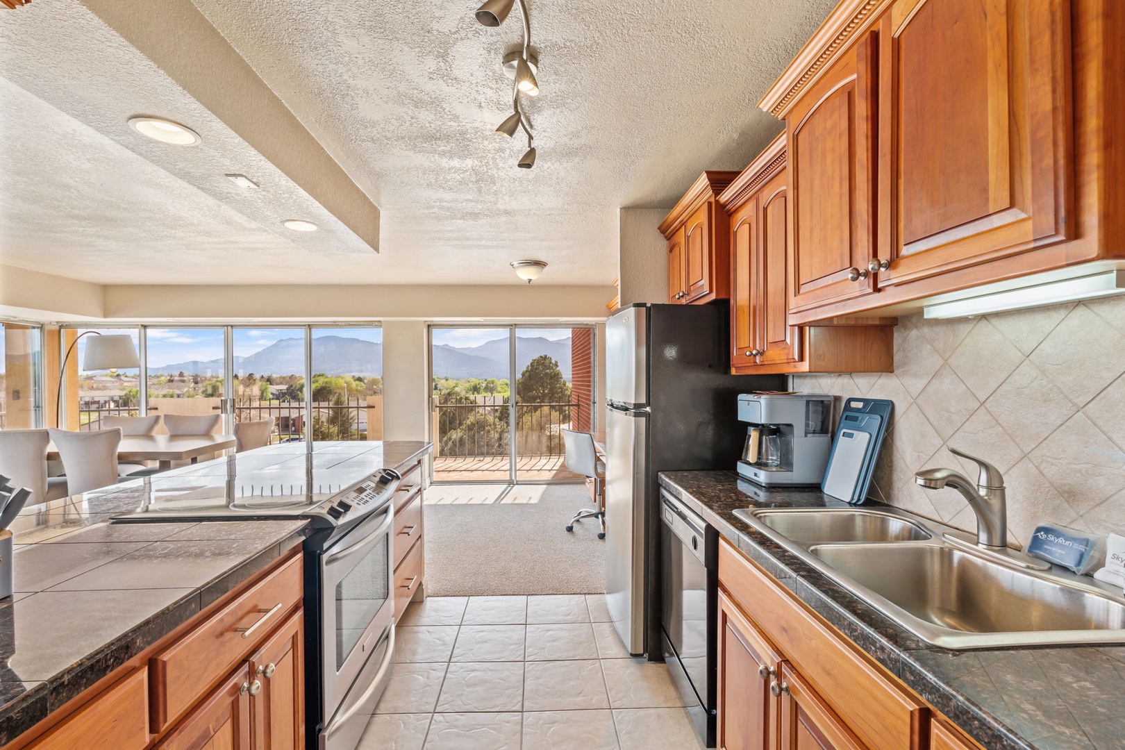 Your fully-equipped kitchen flows into open living and dining spaces, with sweeping mountain views framing every moment of your stay.
