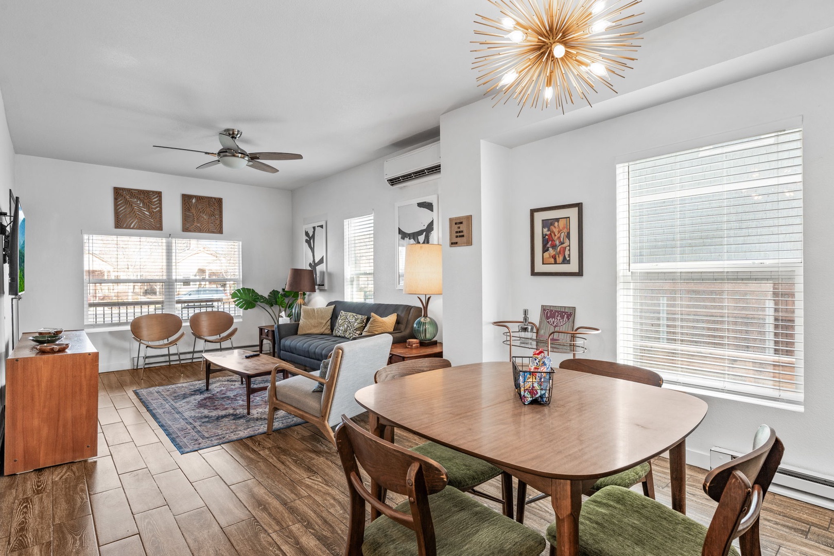 Step into your stylish open-plan living space where modern comfort meets warm wood tones and designer lighting.