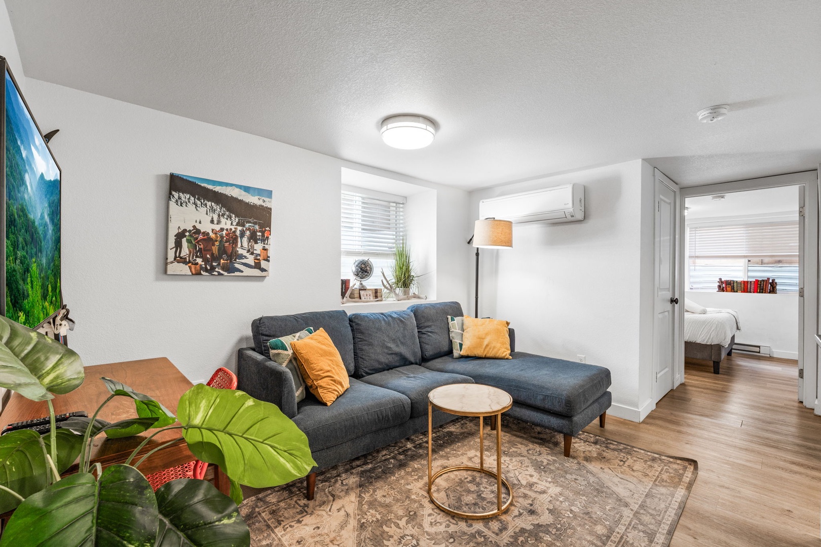 Sink into your comfortable sectional sofa while tropical plants add warmth to your bright, modern living space.