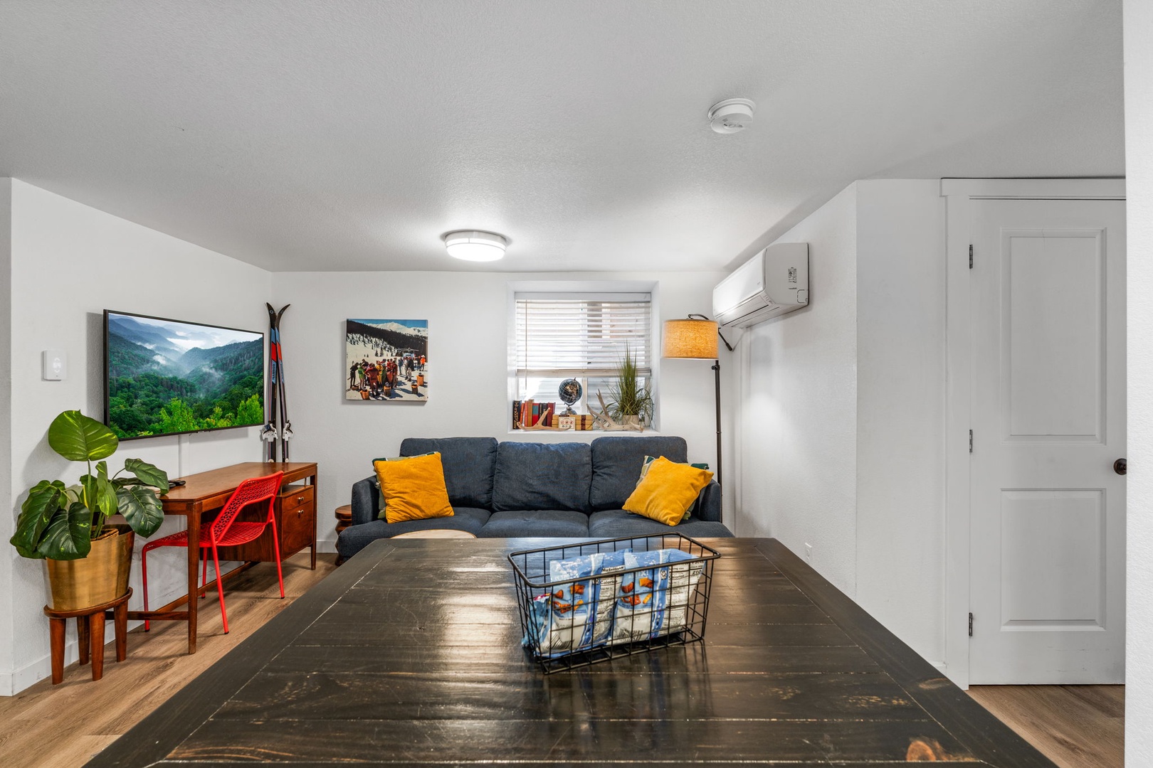 Unwind in your bright, modern living space with comfortable seating, smart TV, and vibrant touches that make relaxation effortless.