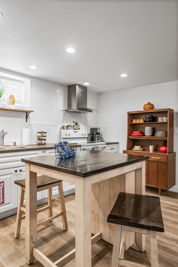 Your fully equipped kitchen invites culinary adventures with modern appliances, spacious island, and warm wood touches for memorable meals.