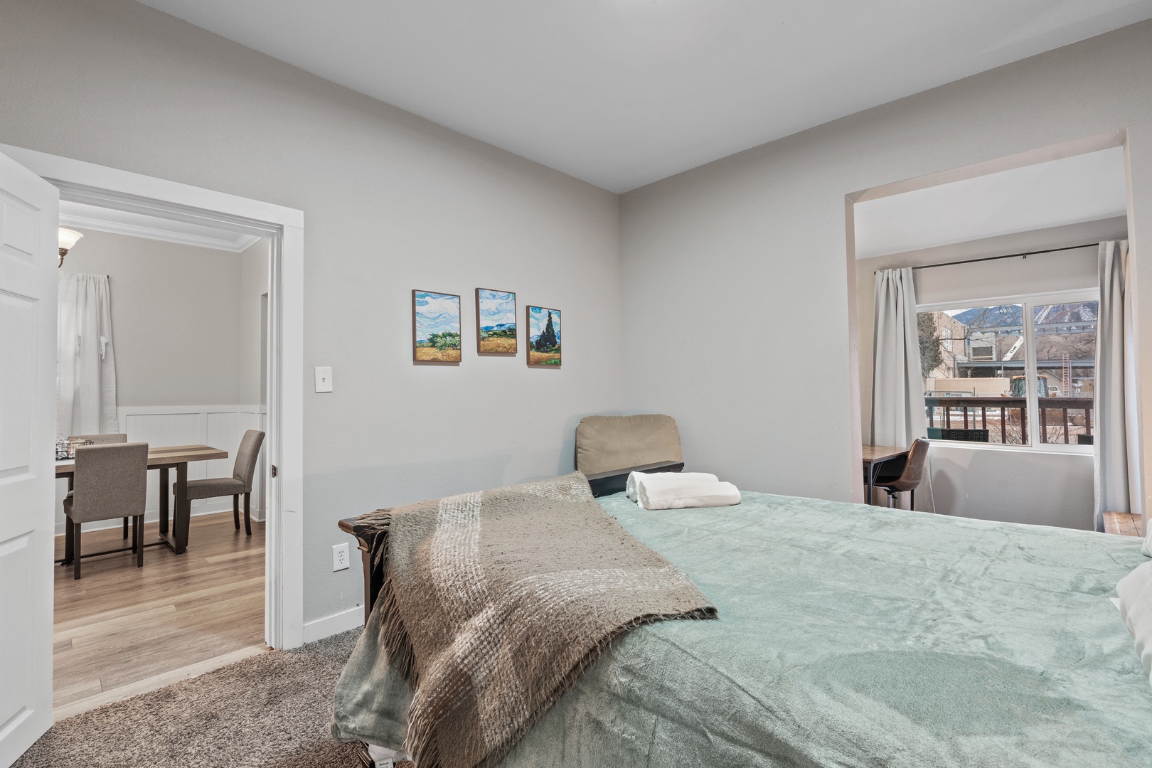 Relax in your peaceful bedroom with soft linens, mountain views from the window, and convenient access to the dining area - your comfortable retreat awaits.