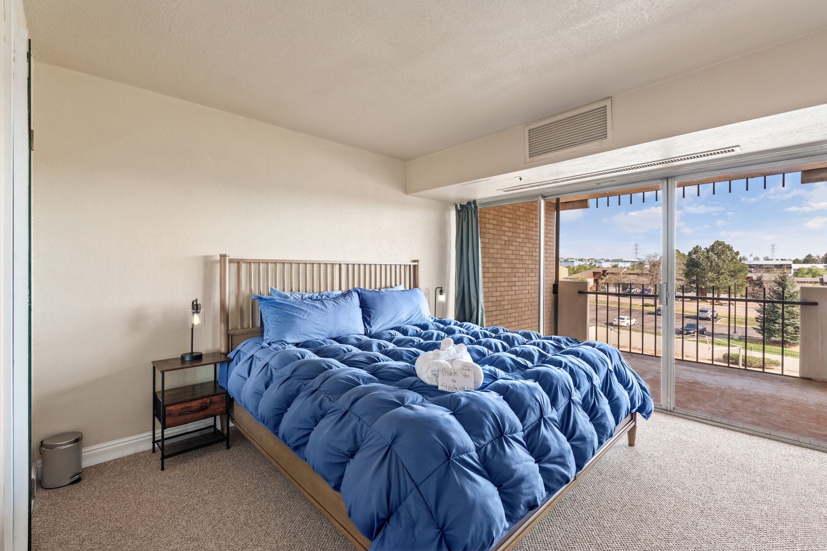 Wake up to natural light streaming through your private balcony doors, where fresh linens and thoughtful touches await your restful stay.