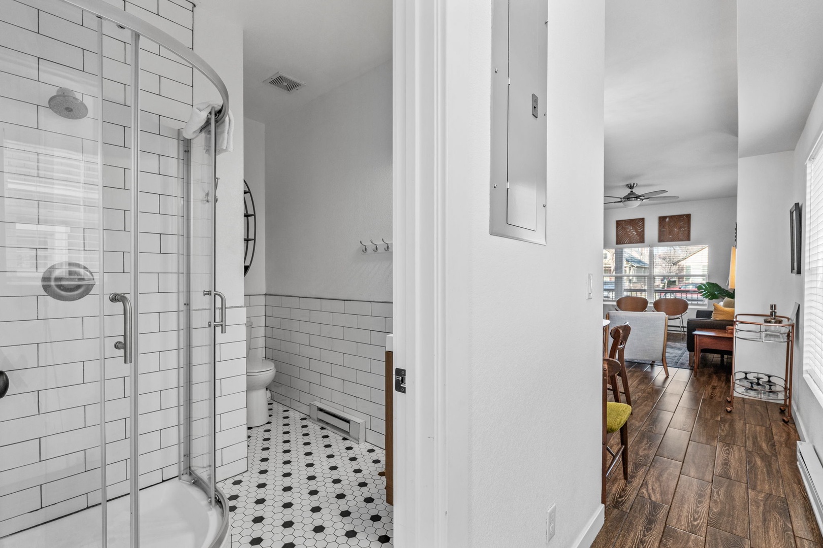 Step into your stylish ensuite with classic subway tiles and glass shower, seamlessly connecting to your open-concept living space.