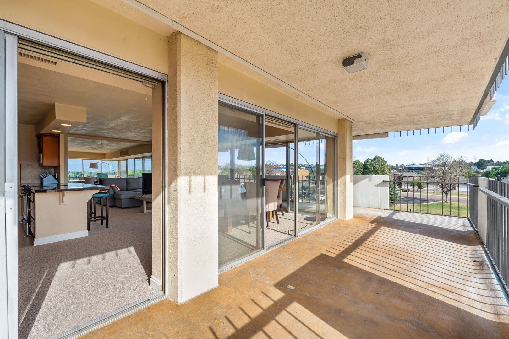 Step onto your private balcony and take in the open neighborhood views. Warm sunlight dances across the deck, inviting you to start your morning coffee here or unwind with an evening breeze.