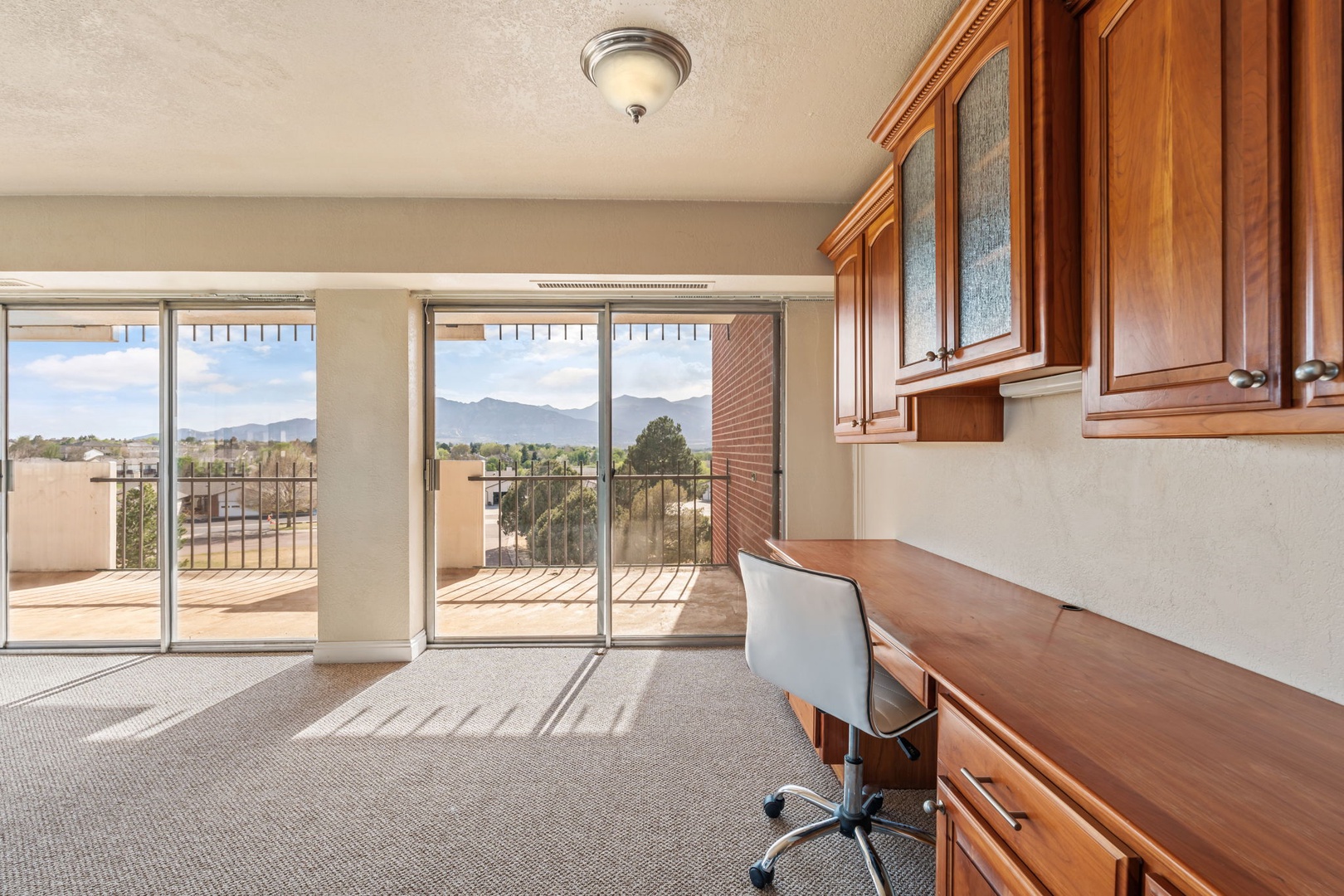 The property offers spectacular views of surrounding mountains and desert landscape through expansive glass doors, creating a scenic backdrop for the area and arrival experience.