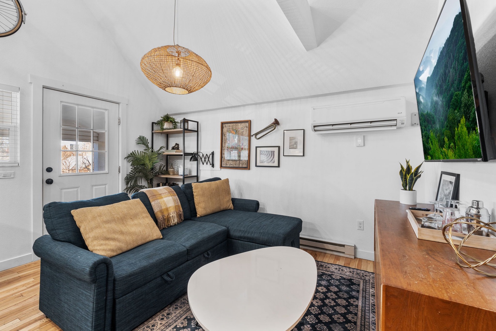 Unwind in your cozy living room featuring a plush sectional sofa, warm wood floors, and thoughtful touches that make you feel right at home.