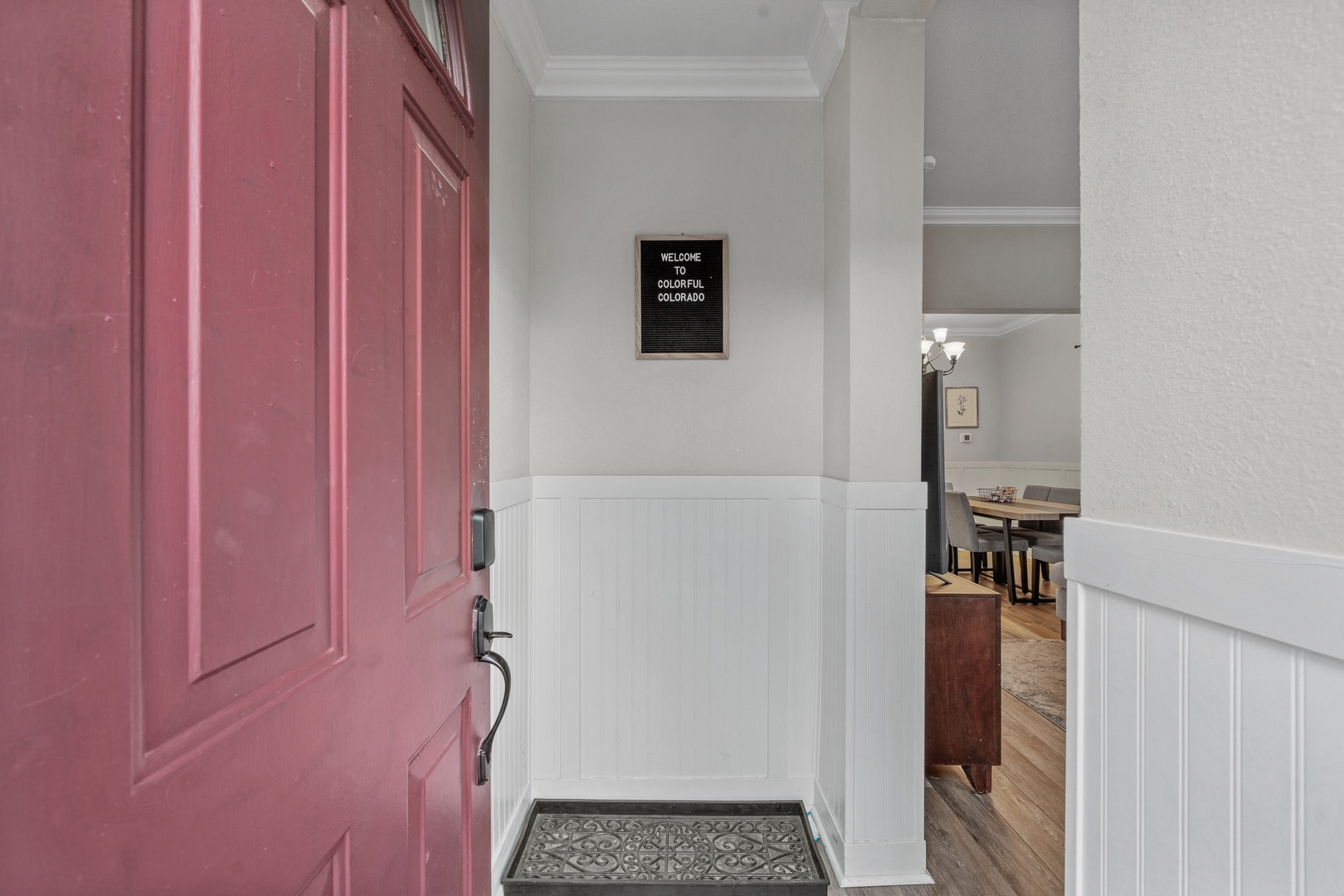 Step through the charming entrance into your welcoming home away from home, where thoughtful details and warm wainscoting create an inviting first impression.