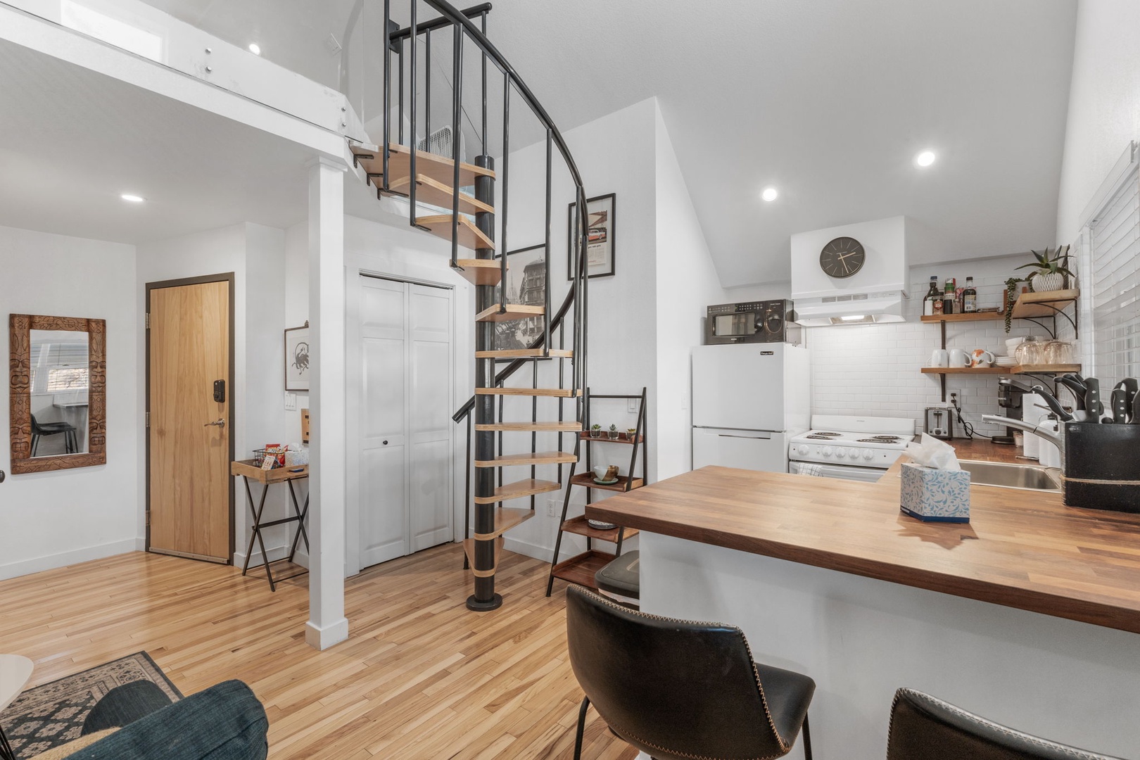 Your stylish loft features soaring ceilings and a stunning spiral staircase, creating an open, airy atmosphere perfect for relaxation.