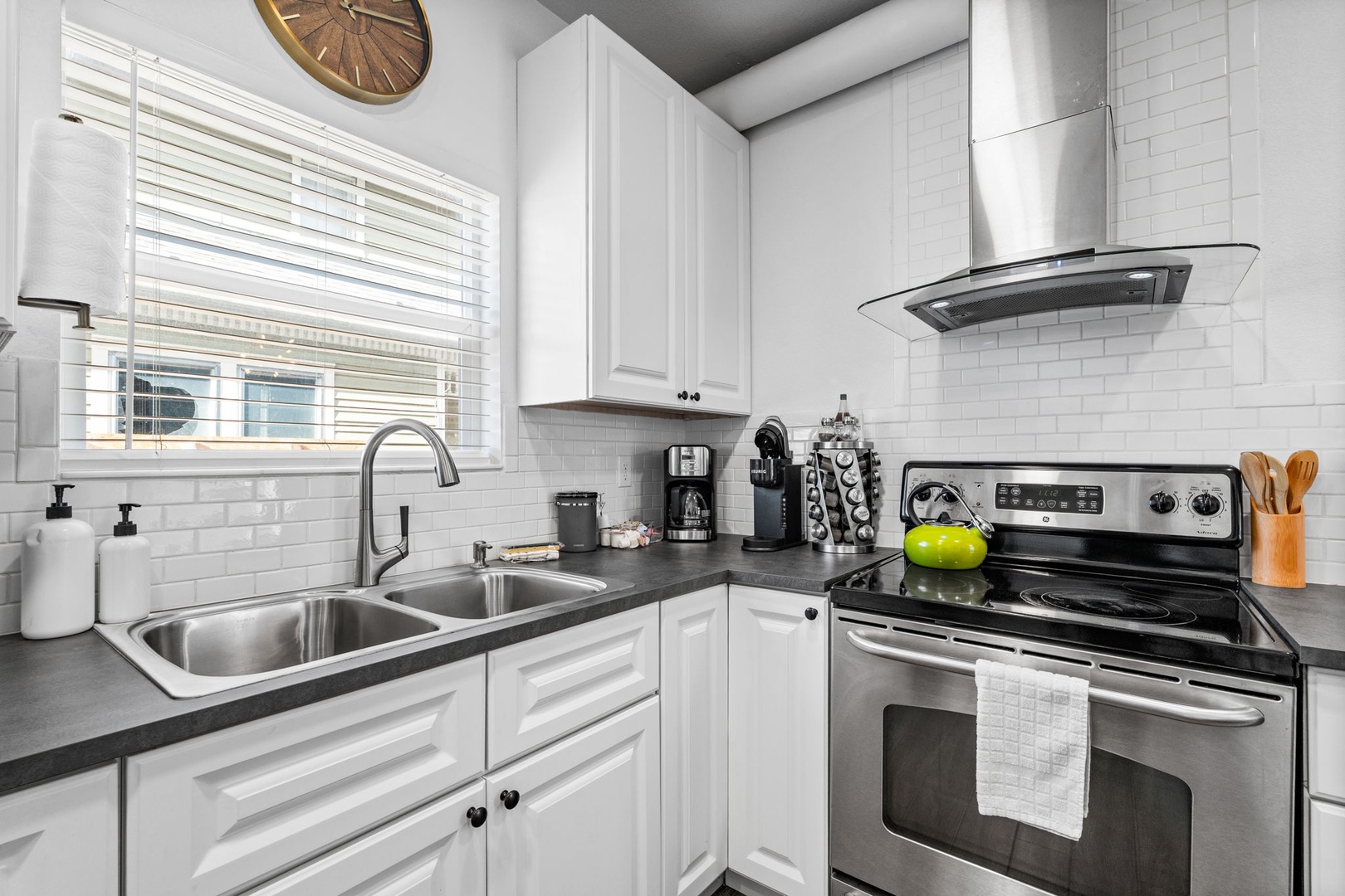 Your fully equipped kitchen awaits with sleek white cabinets, stainless steel appliances, and everything needed for home cooking.