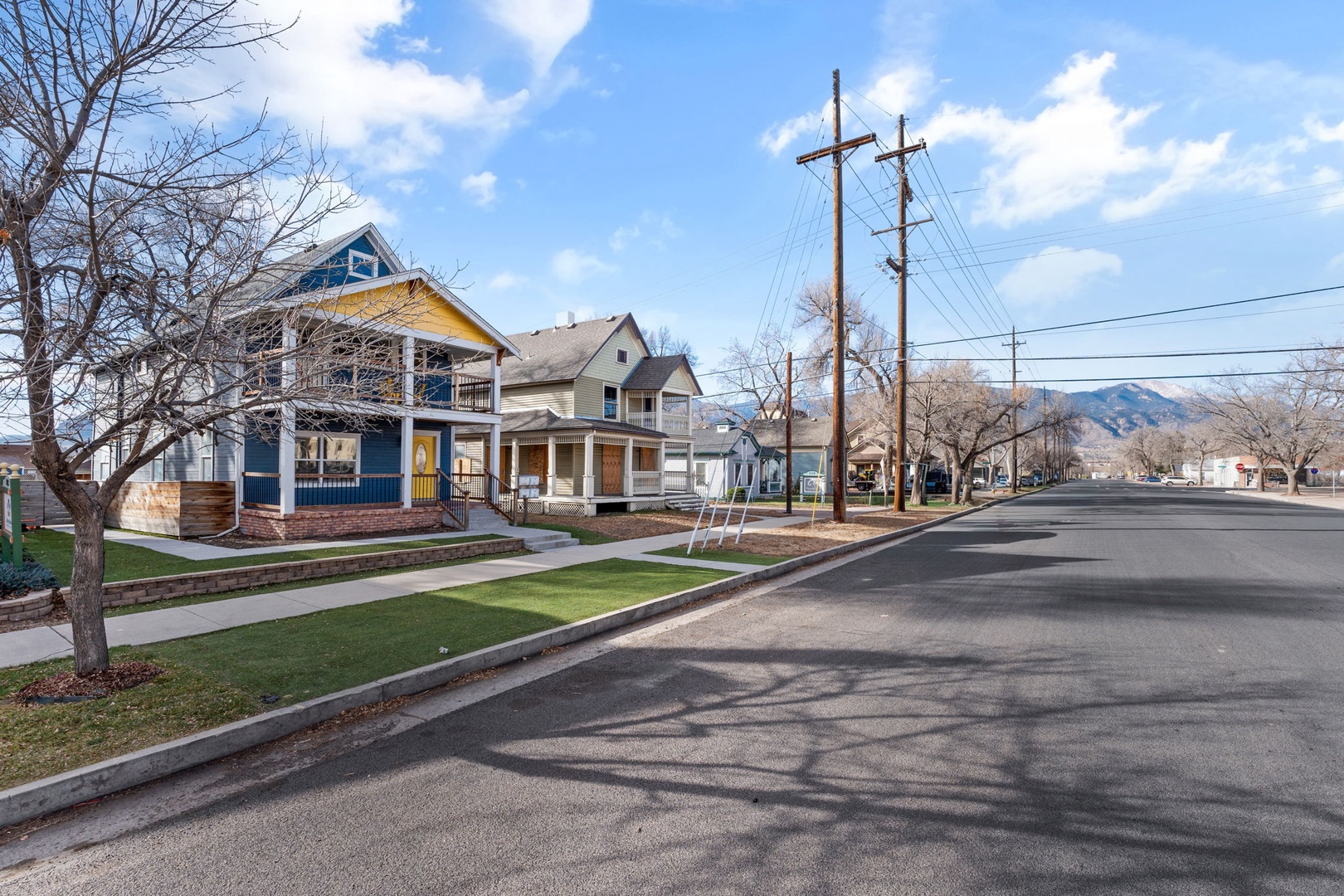 A peaceful residential street lined with charming homes in a mountain town setting.