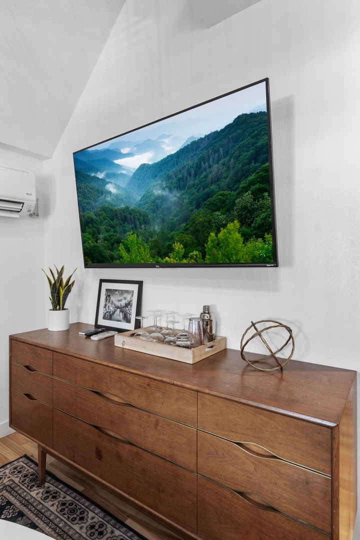 Unwind in your stylish entertainment area featuring a large TV and elegant furnishings for cozy movie nights.