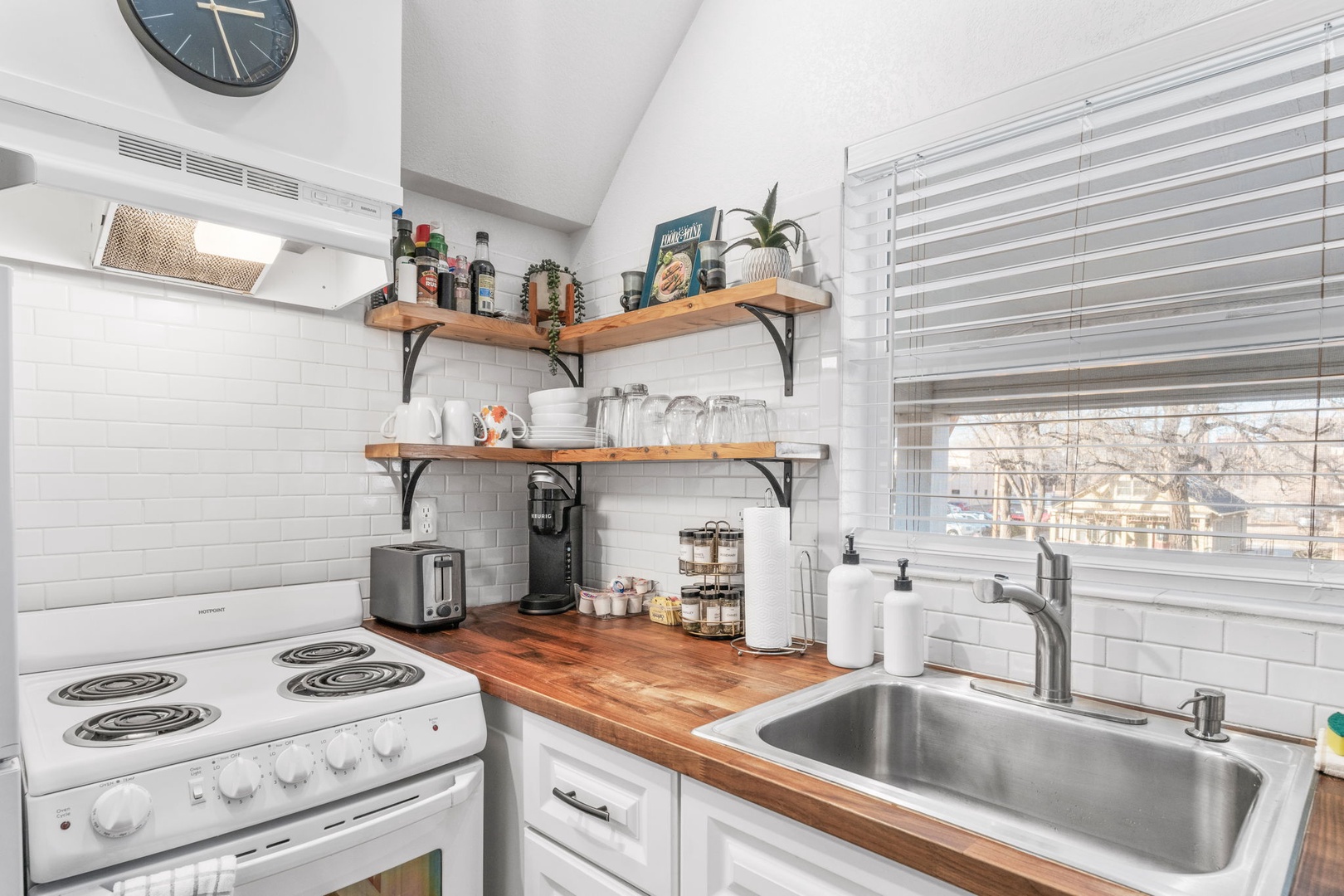 Your fully equipped kitchen features warm wood counters, subway tile backsplash, and everything you need to create memorable meals during your stay.