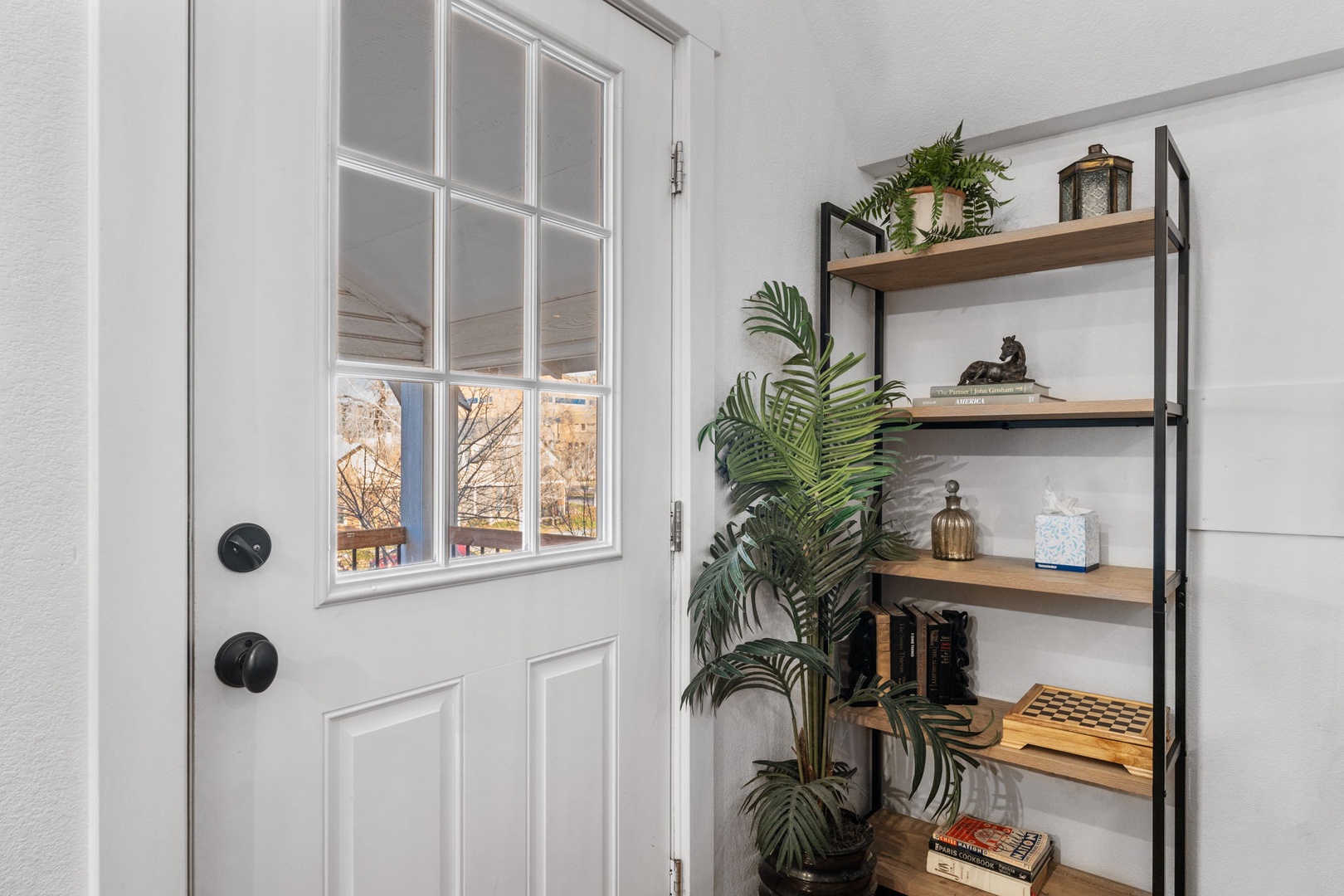 Your welcoming entry greets you with natural light through glass doors and thoughtful touches like greenery and curated décor.