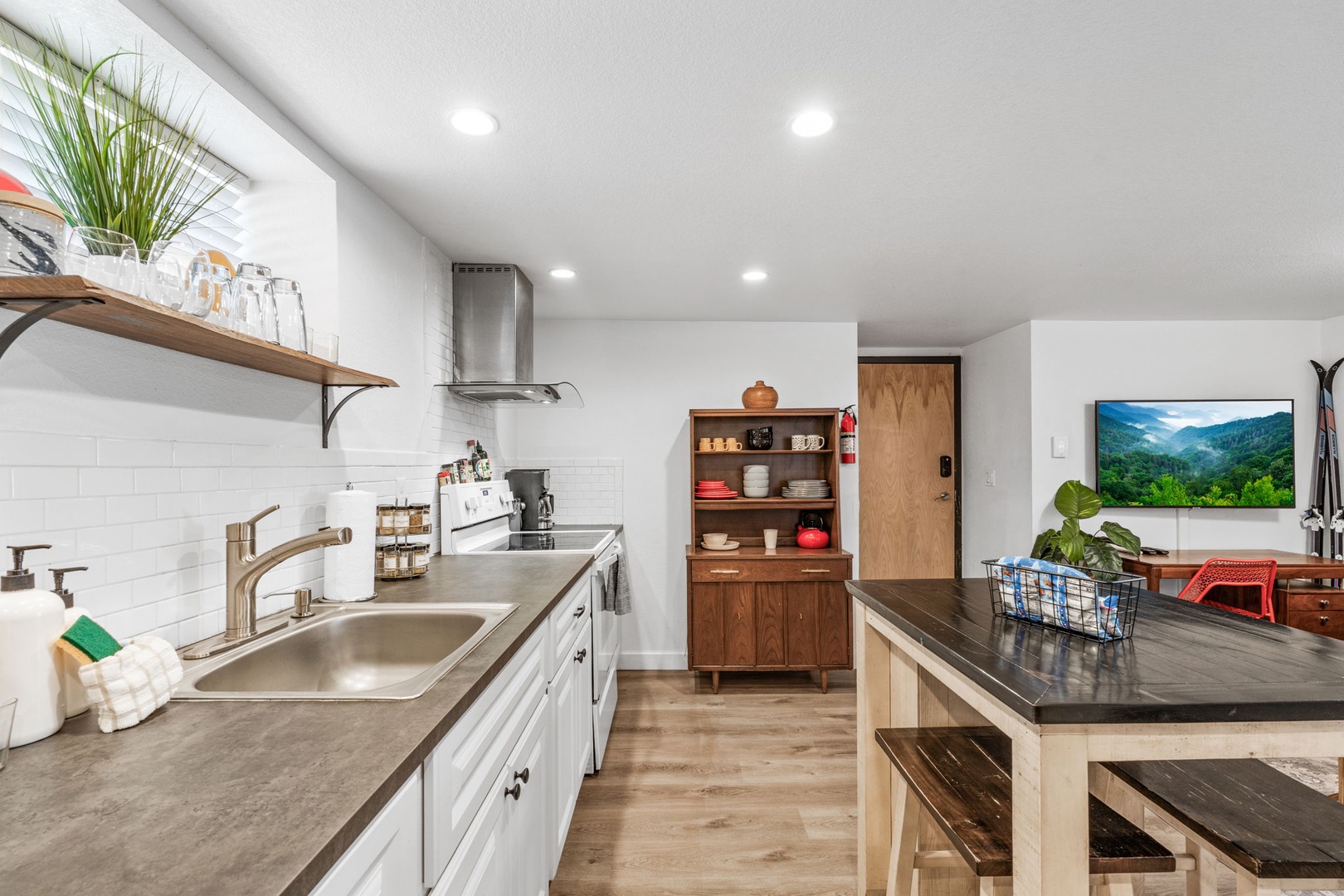 Your fully equipped kitchen invites culinary creativity with modern appliances, spacious counters, and warm wood accents perfect for memorable meals.
