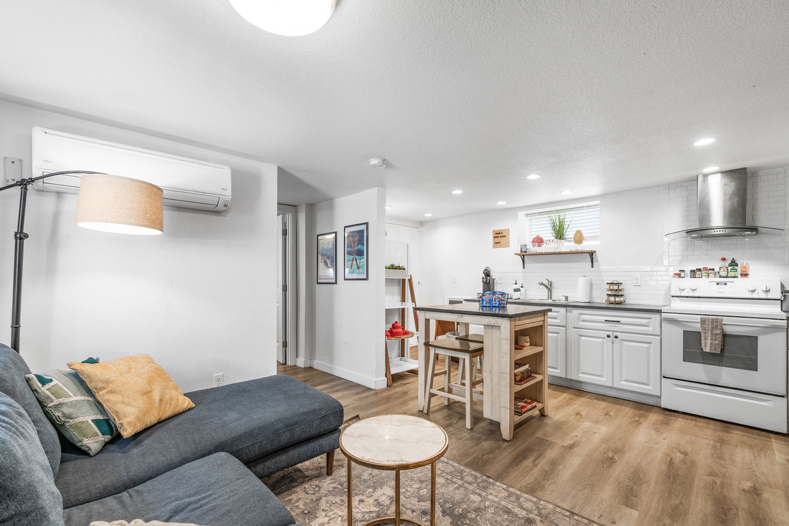 Your modern open-plan living space combines comfort and functionality with a fully equipped kitchen, cozy seating, and stylish touches throughout.