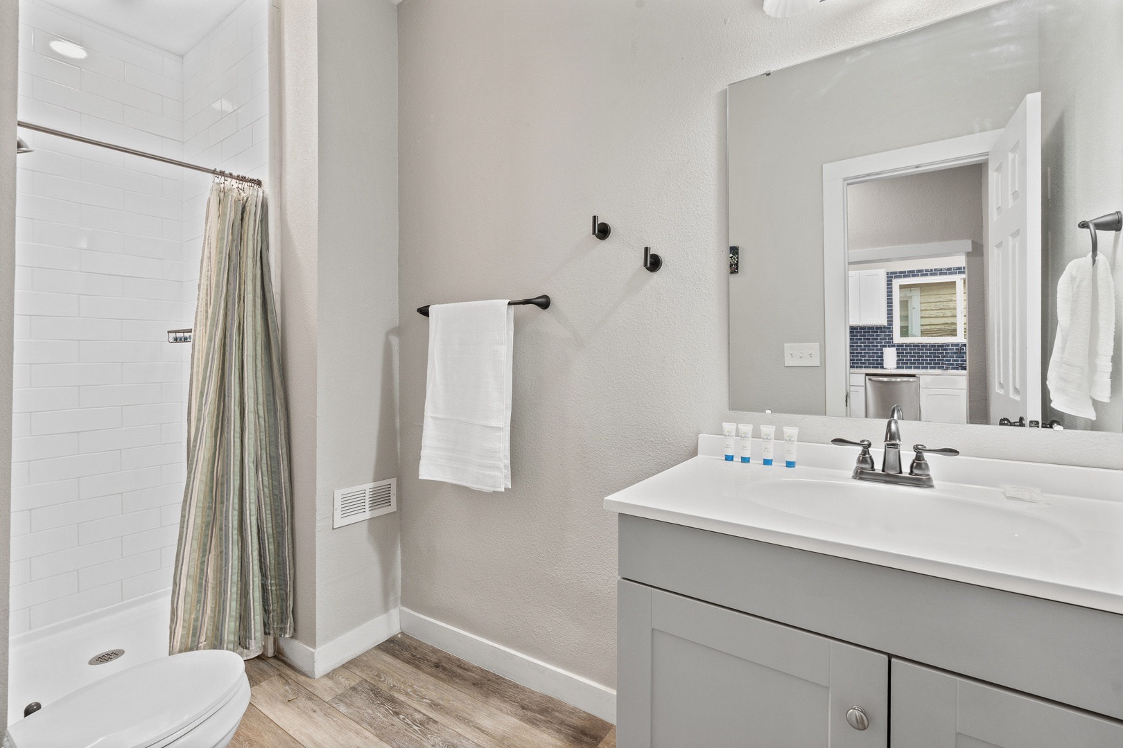Your modern bathroom features a spacious shower, elegant vanity with premium fixtures, and fresh towels ready for your stay.