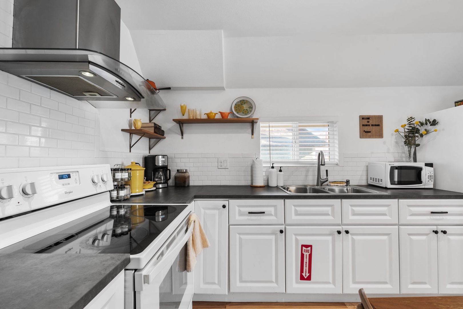 Your modern kitchen features sleek white cabinets, granite countertops, and everything you need for home-cooked meals during your stay.