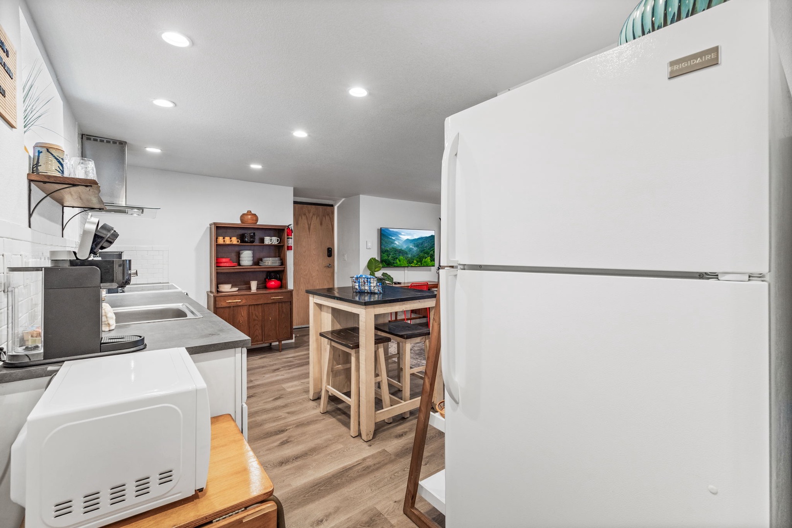 Your fully equipped kitchen includes everything needed for home cooking—full-size refrigerator, microwave, dishwasher, and cozy dining space.