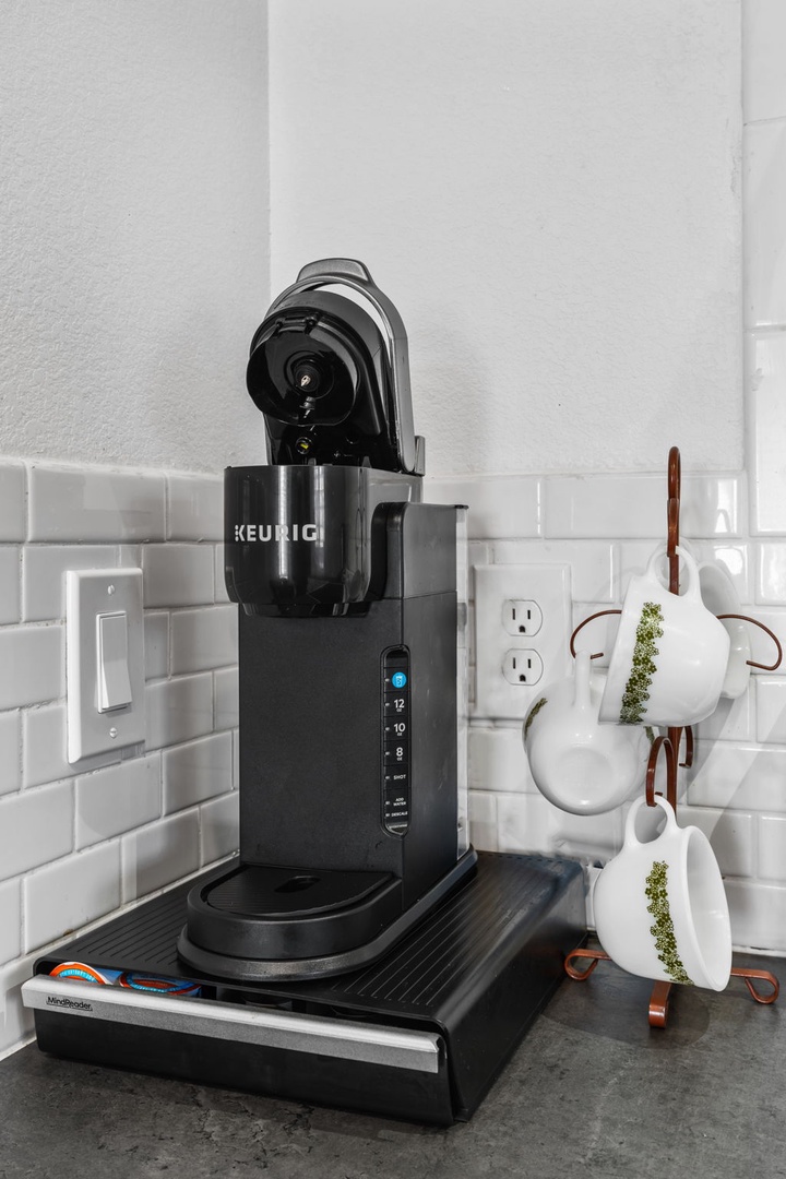 Start your mornings with fresh Keurig coffee and charming ceramic mugs in your well-equipped kitchen corner.