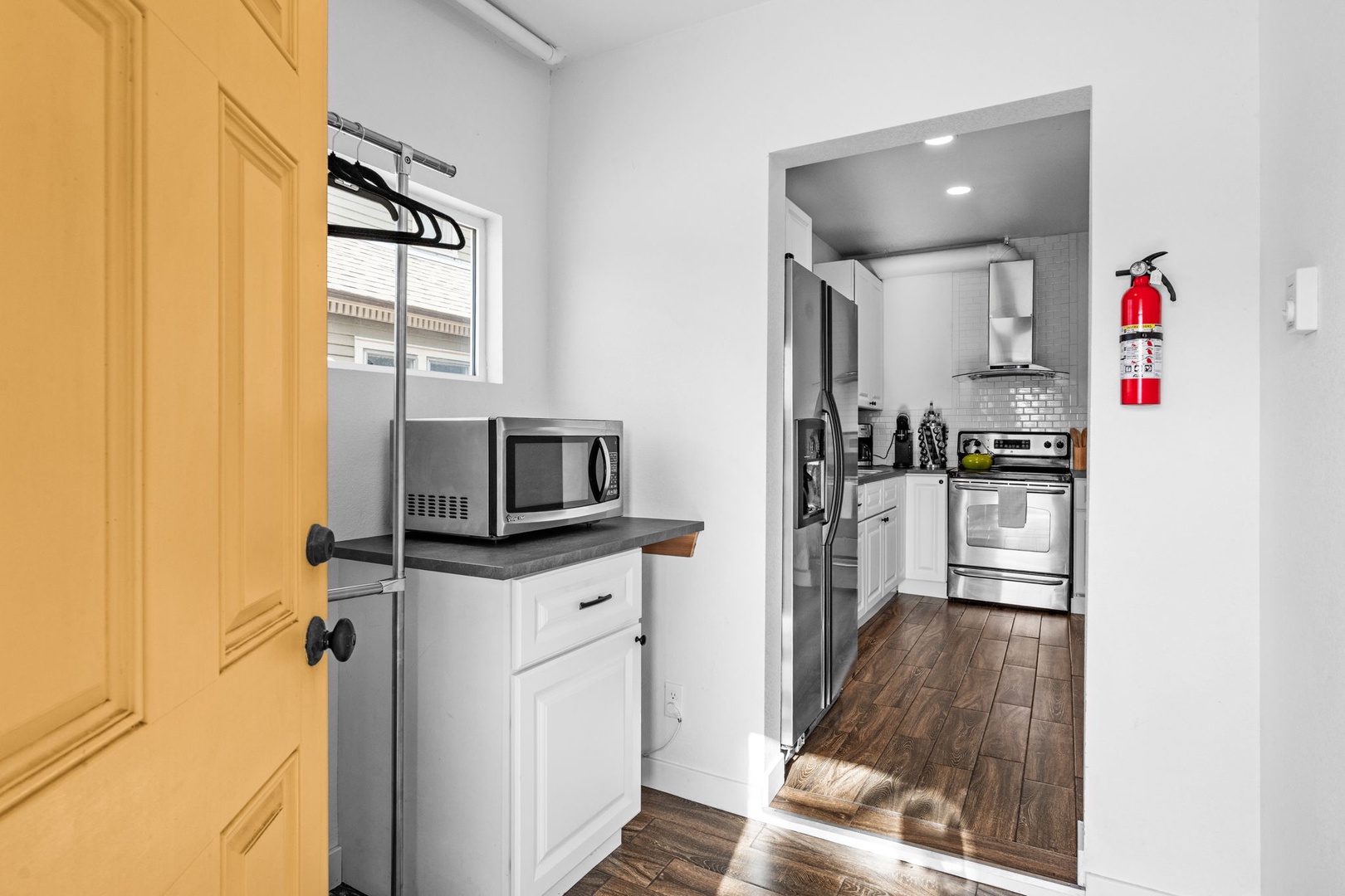 Your fully equipped kitchen awaits with modern appliances and bright white cabinets, perfect for preparing meals during your stay.