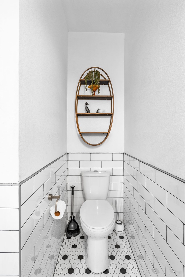 Your private powder room features classic subway tiles, charming hexagon floors, and thoughtful touches that make this space feel like home.