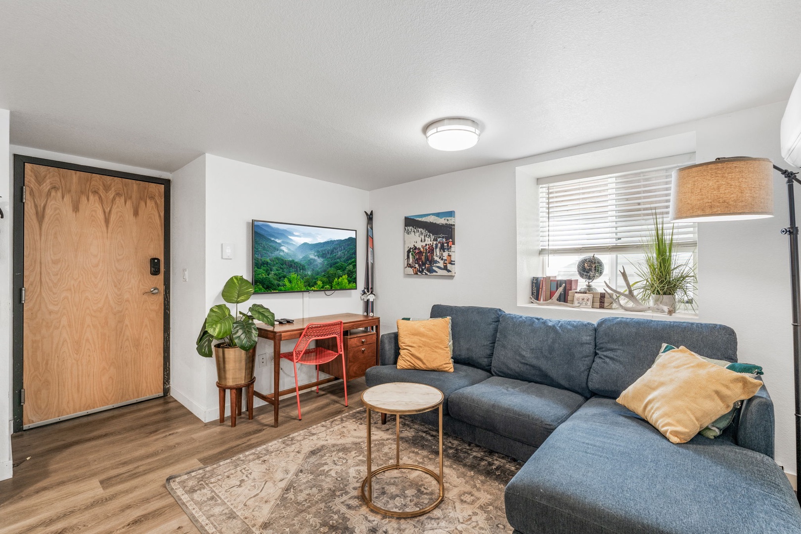 Sink into your cozy sectional sofa and unwind while streaming your favorite shows on the large flat-screen TV in this thoughtfully designed living space.