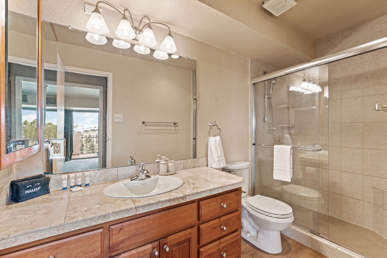 Freshen up in your private bathroom with a walk-in shower, warm lighting, and plenty of counter space for your essentials.