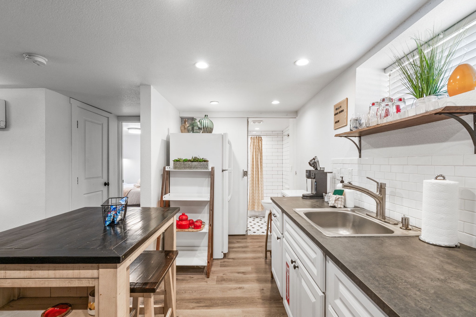 Your bright kitchen awaits with modern appliances, spacious counters, and charming touches perfect for preparing memorable meals during your stay.