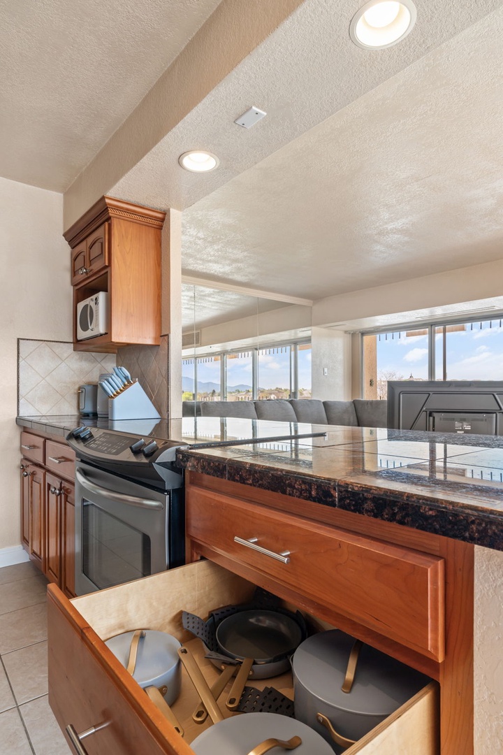 Your fully equipped kitchen has everything you need, from quality cookware to a convenient microwave. Natural light floods the space, and you'll love the vaulted ceiling with recessed lighting as you prepare memorable meals.