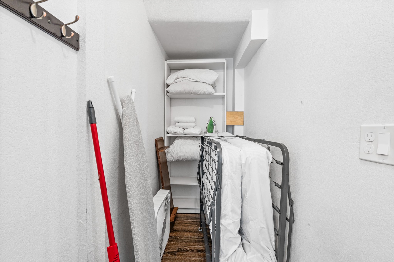 Your private cleaning closet keeps everything organized with fresh linens and housekeeping essentials neatly stored for your convenience.