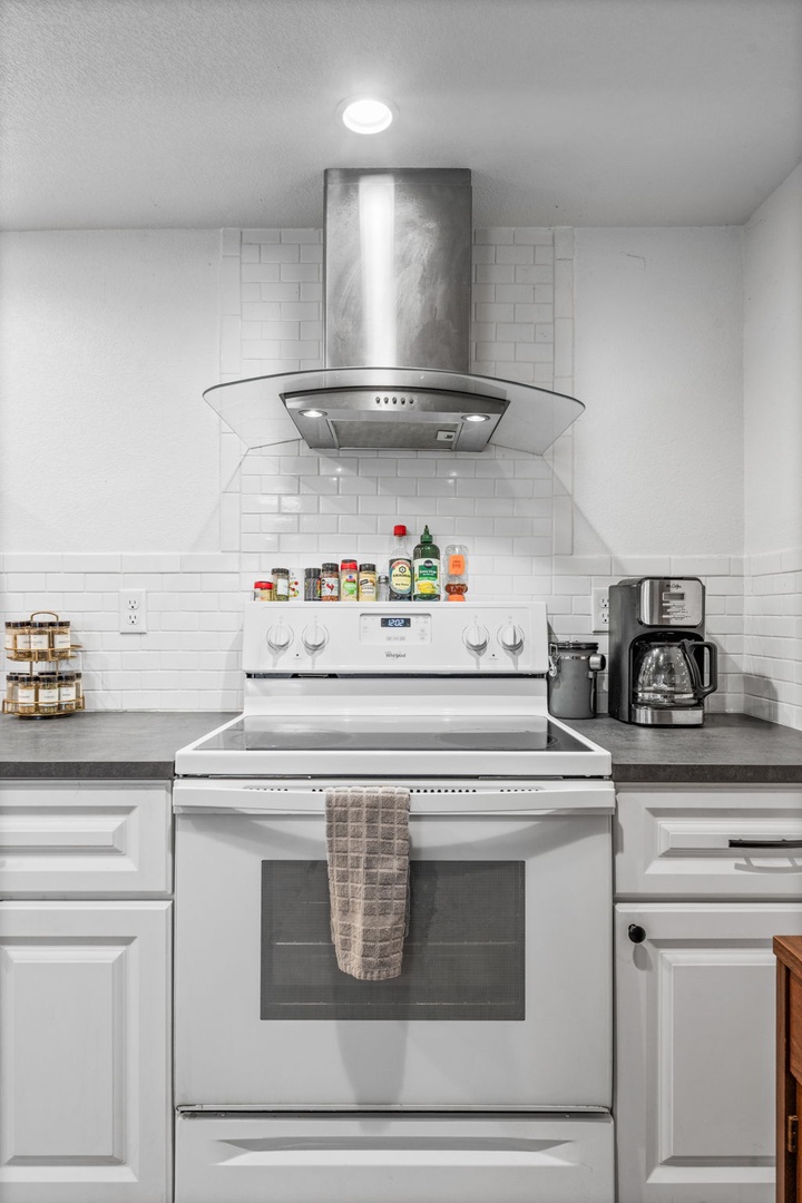 Cook your favorite meals in this bright, modern kitchen with sleek appliances and stylish subway tile backsplash.
