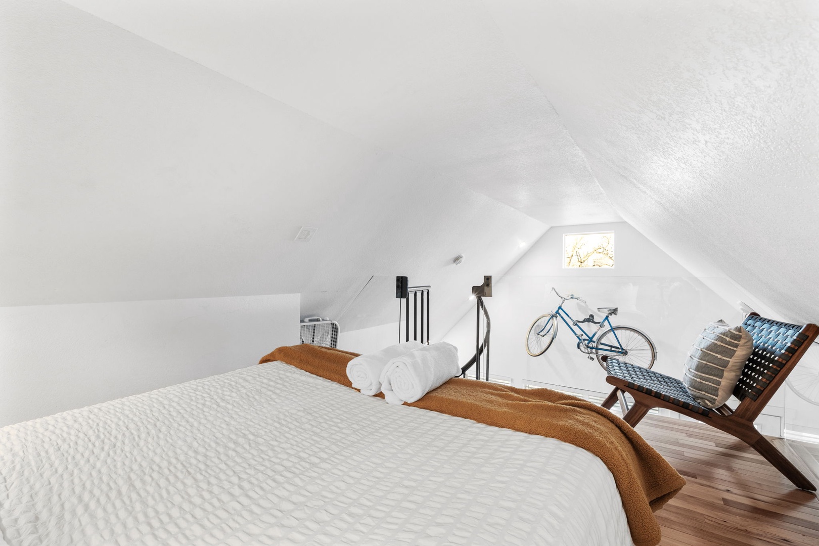 Your cozy attic retreat awaits with warm wooden accents and thoughtful touches for a peaceful stay.