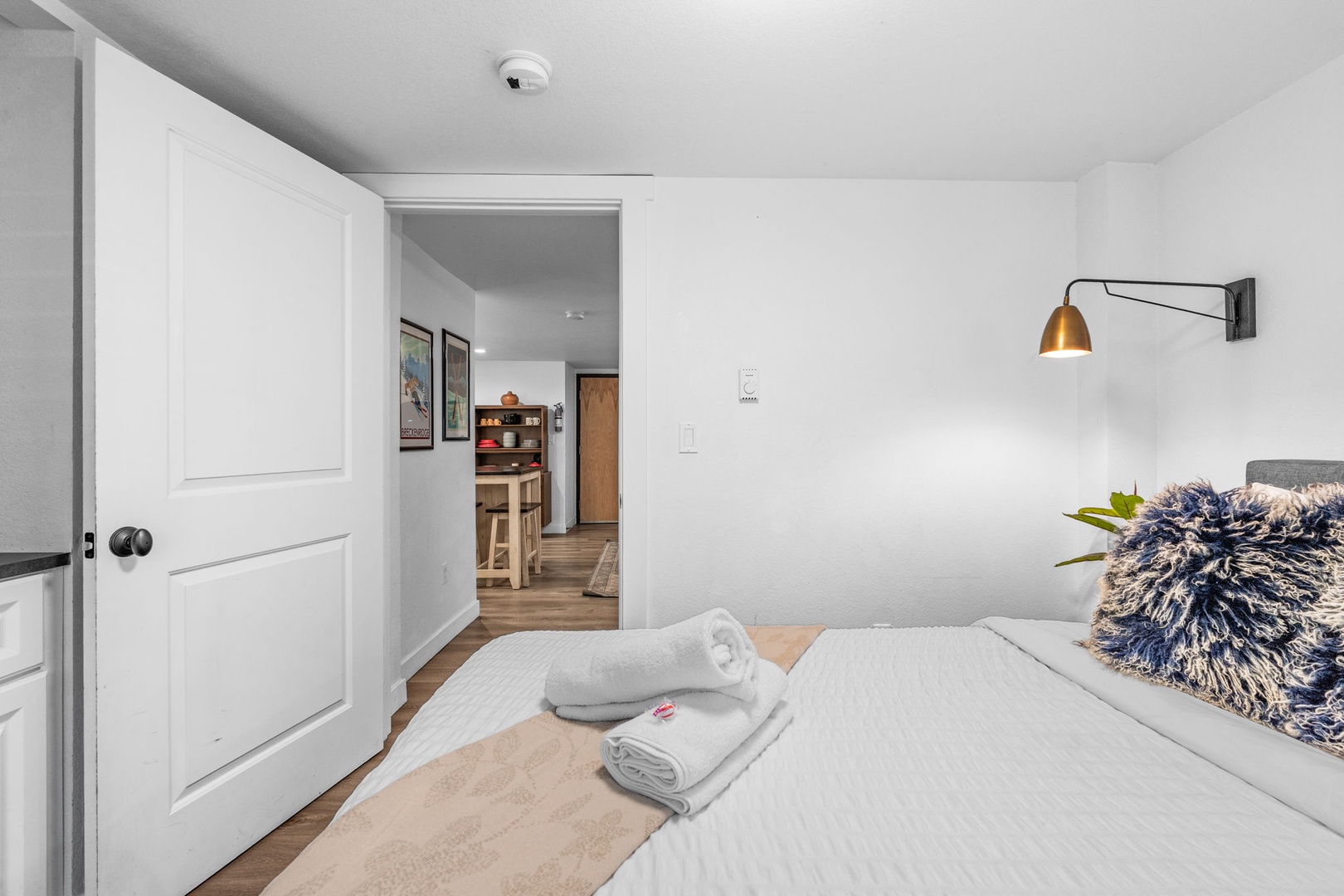 Rest in this thoughtfully designed bedroom where modern touches like brass wall lighting create a warm ambiance for your stay.