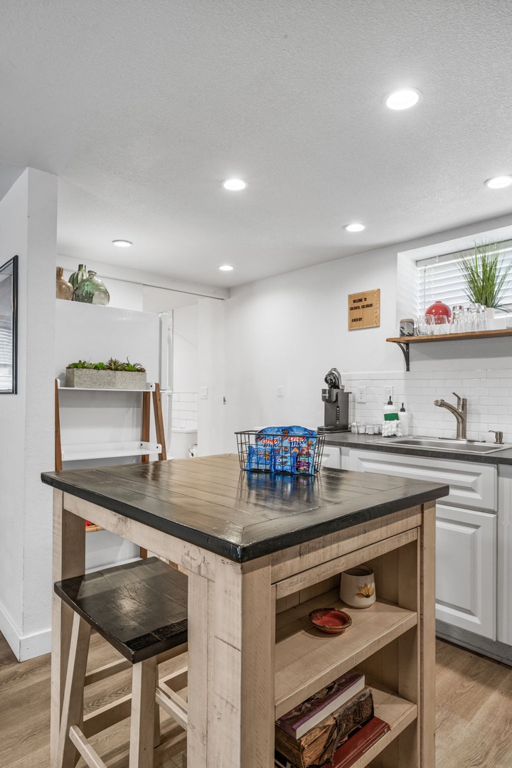 Your bright kitchen features a charming rustic island perfect for morning coffee and meal prep with modern appliances at your fingertips.