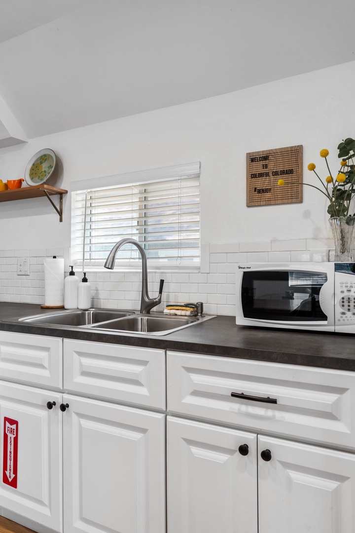 Your bright kitchen features everything you need with modern appliances, granite counters, and subway tile charm.