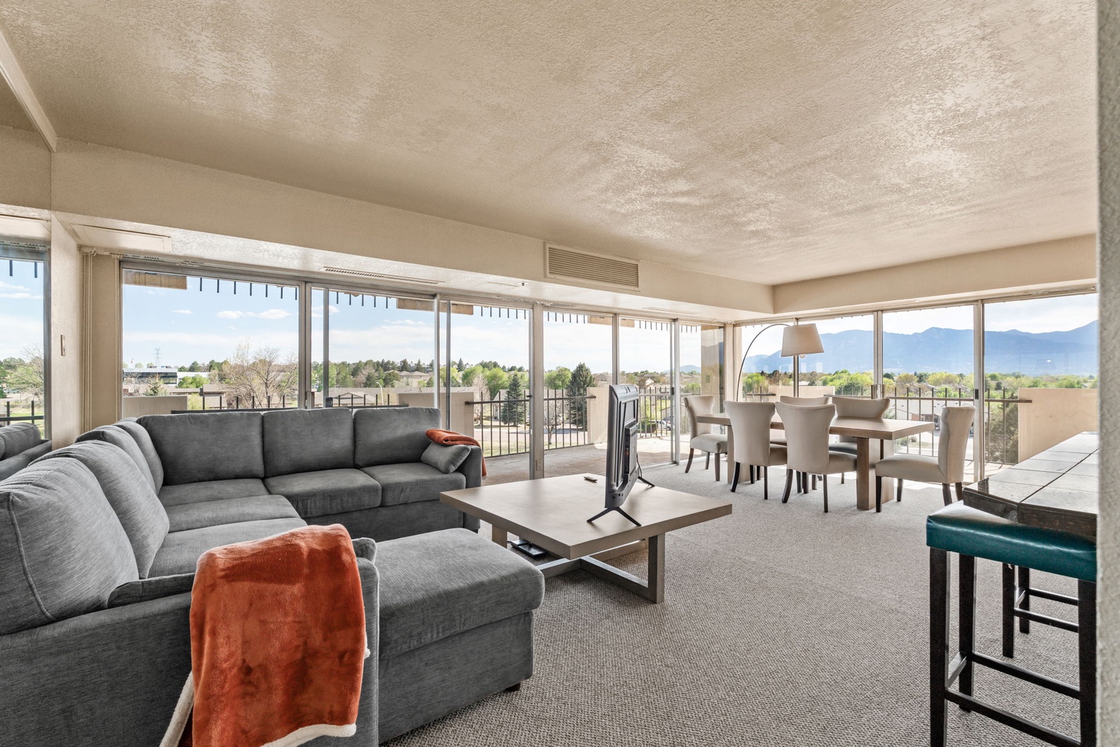 Sink into plush seating as you take in sweeping mountain views through floor-to-ceiling windows. Your spacious living and dining area opens to a private balcony—perfect for morning coffee or evening relaxation.