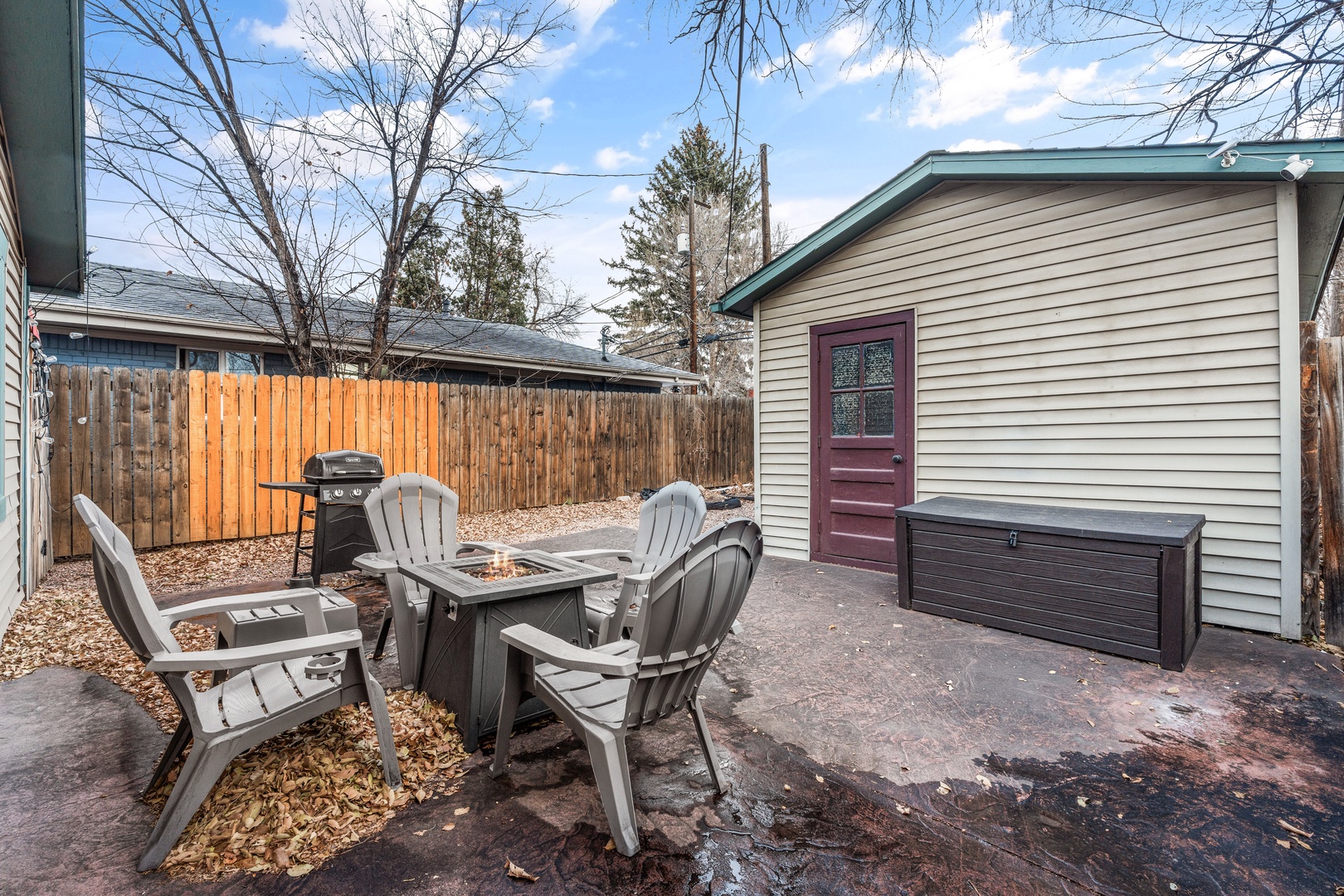 Gather around your private fire pit table for cozy evenings outdoors, with comfortable Adirondack seating and convenient BBQ access in your enclosed backyard.