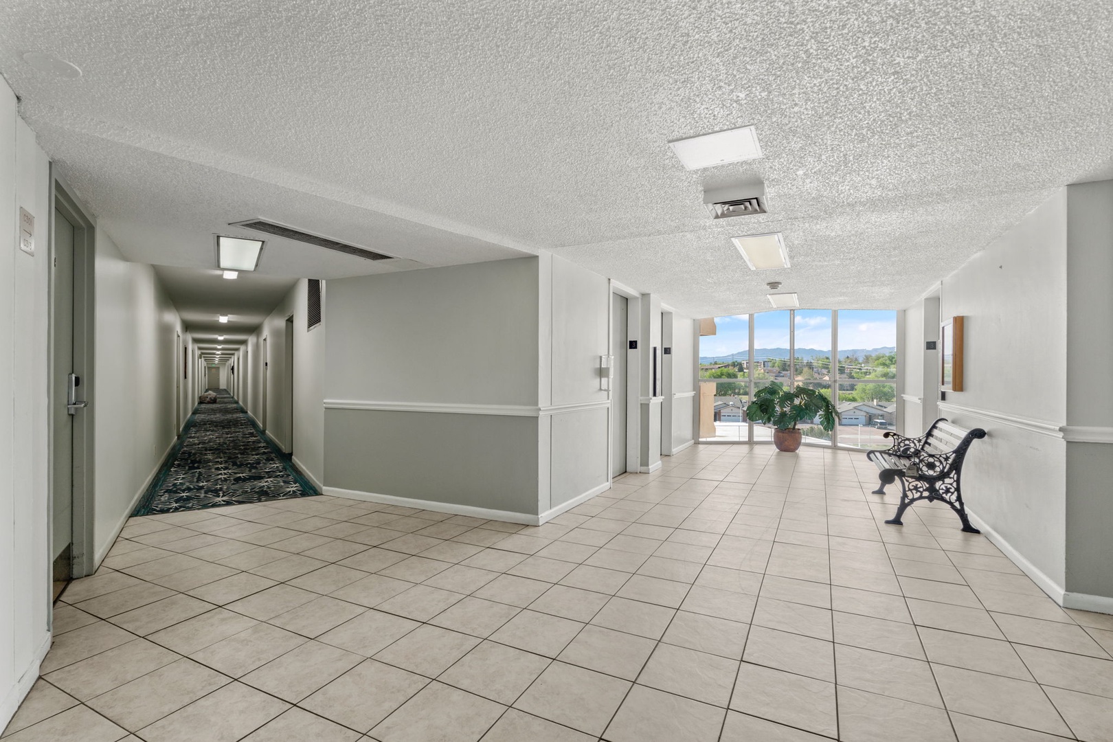 The property features bright hallways with scenic city views, tiled floors, and comfortable seating areas where you can pause and enjoy the panorama.