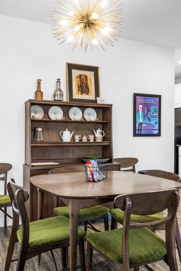Gather around your elegant dining table beneath the stunning starburst chandelier, creating memorable moments in this stylish space.
