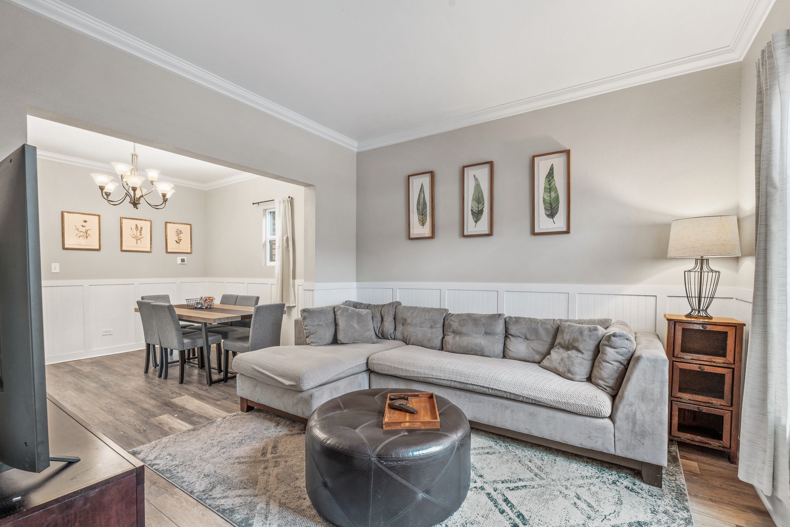 Relax in your spacious living room with plush seating and stylish decor, seamlessly connected to the dining area for comfortable entertaining.