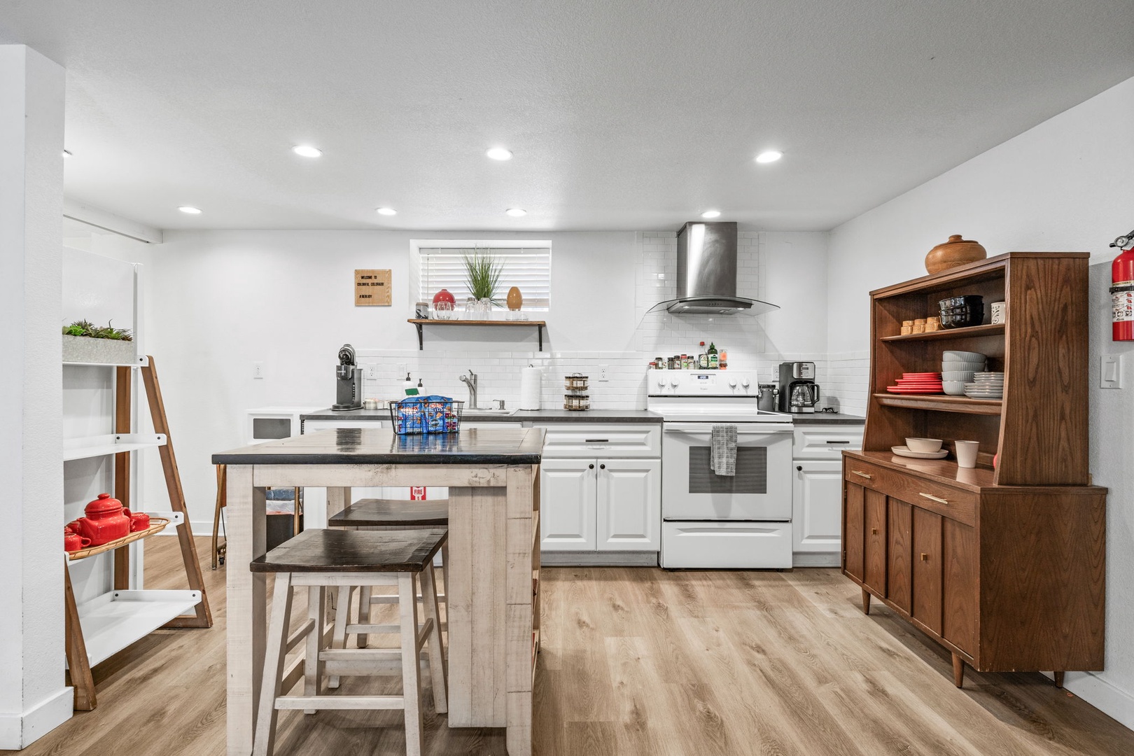 Your fully equipped kitchen awaits with modern appliances, spacious island seating, and warm wood accents for memorable meal preparation.