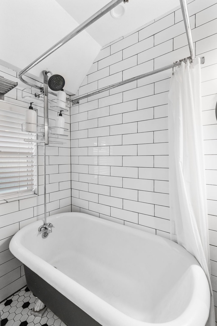 Slip into your vintage-style bathtub surrounded by classic white subway tiles for a relaxing soak after your day of exploring.