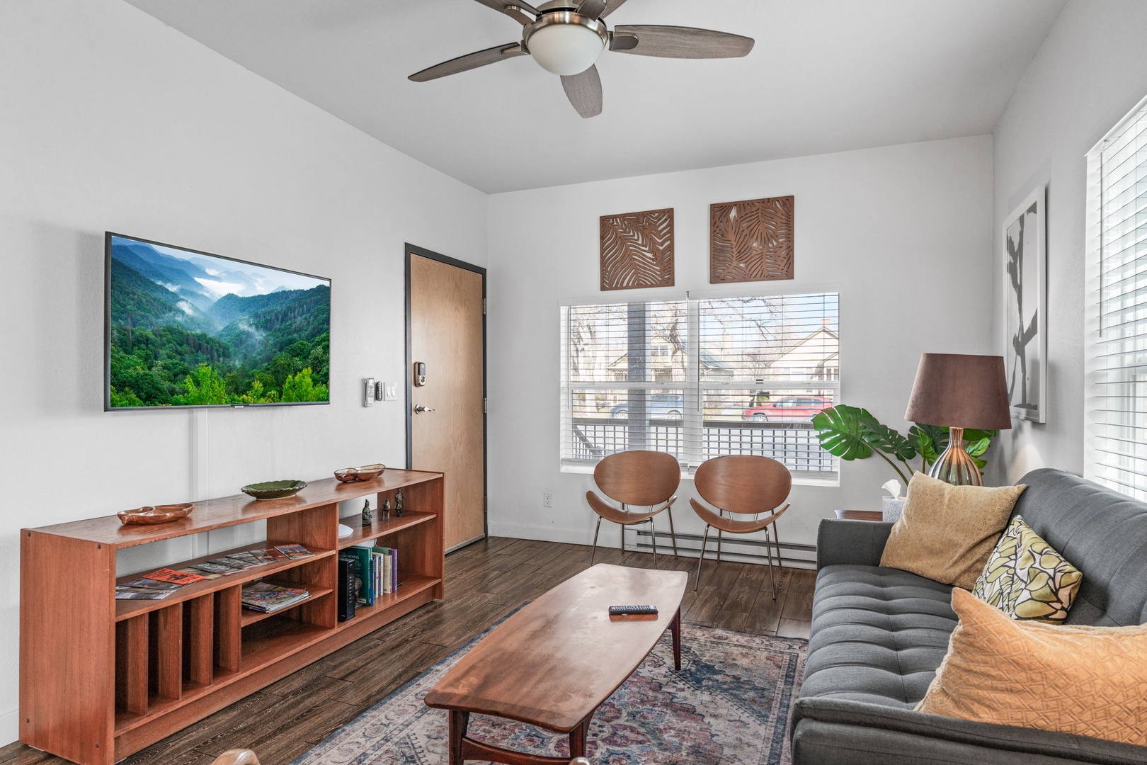 Unwind in your stylish living space with modern comfort and natural light streaming through large windows.